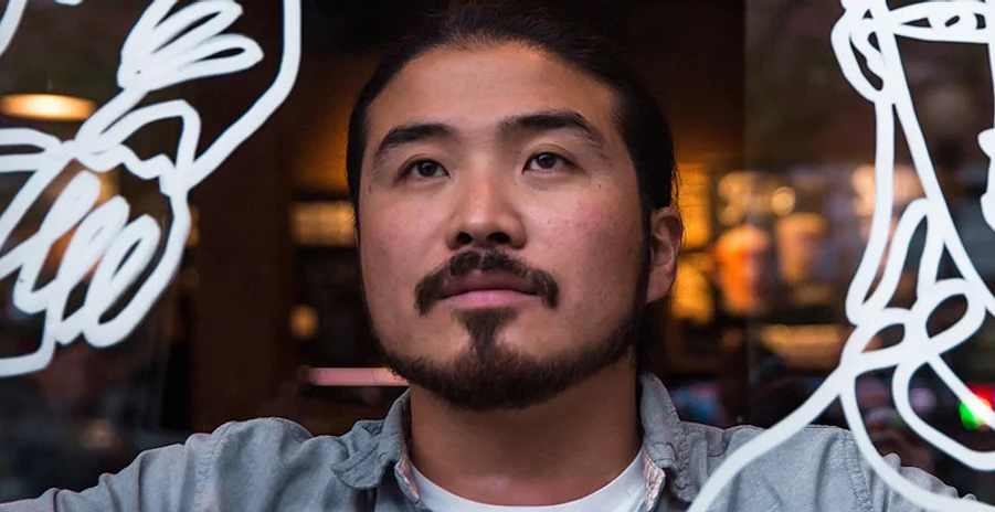 artist Shogo Ota viewed through a painted window