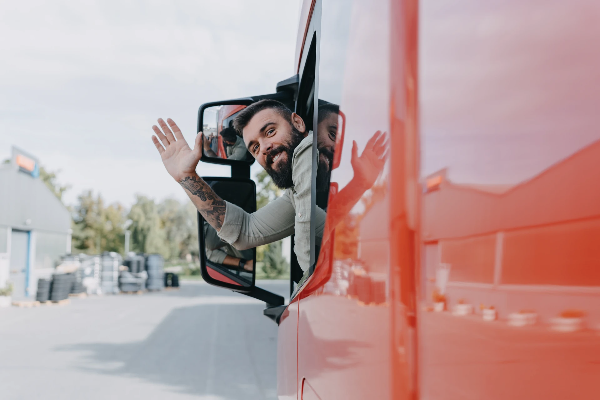 Truck driver waving from vehicle