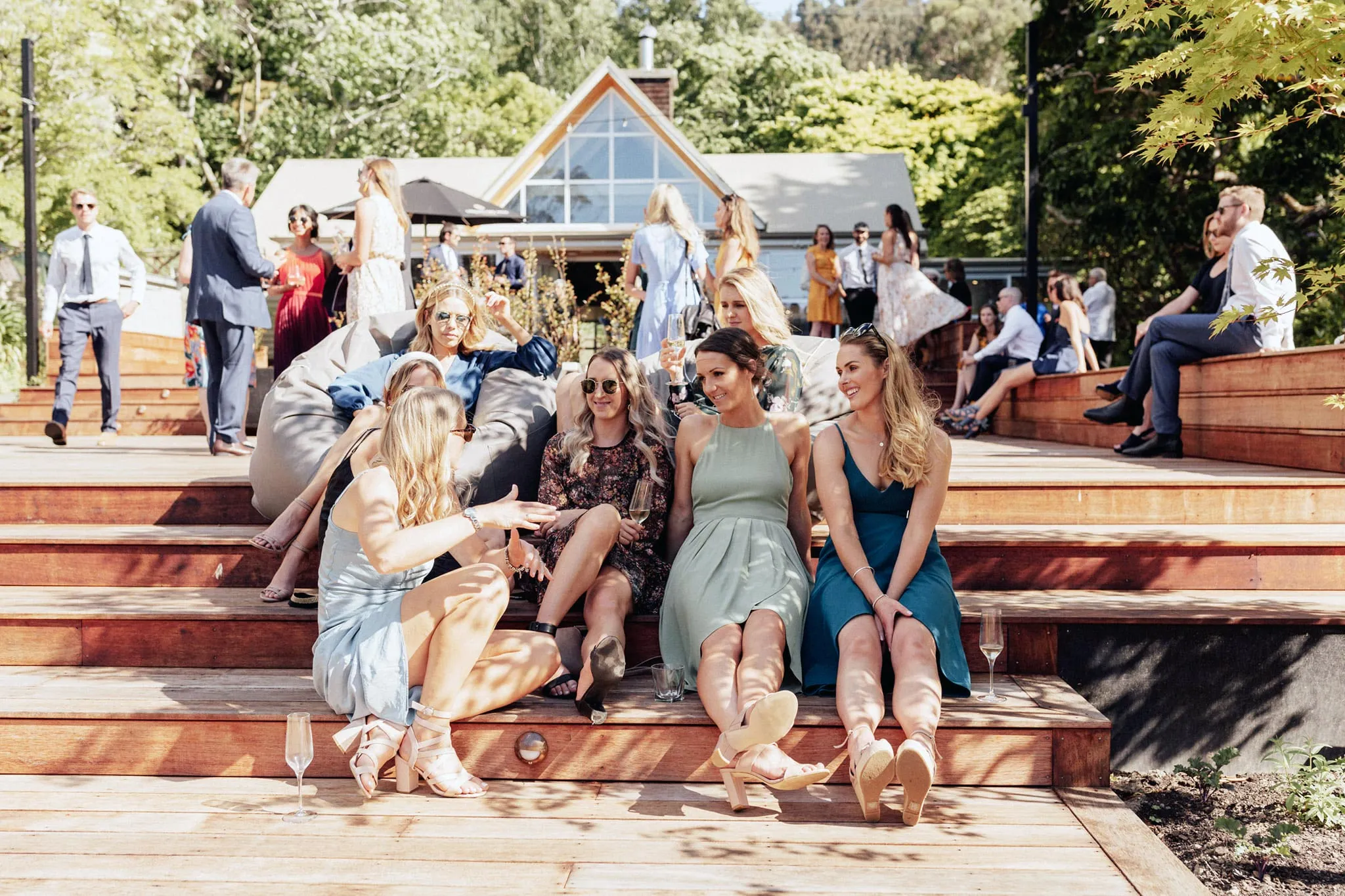 Group of people sit in sun on Glenfalloch deck