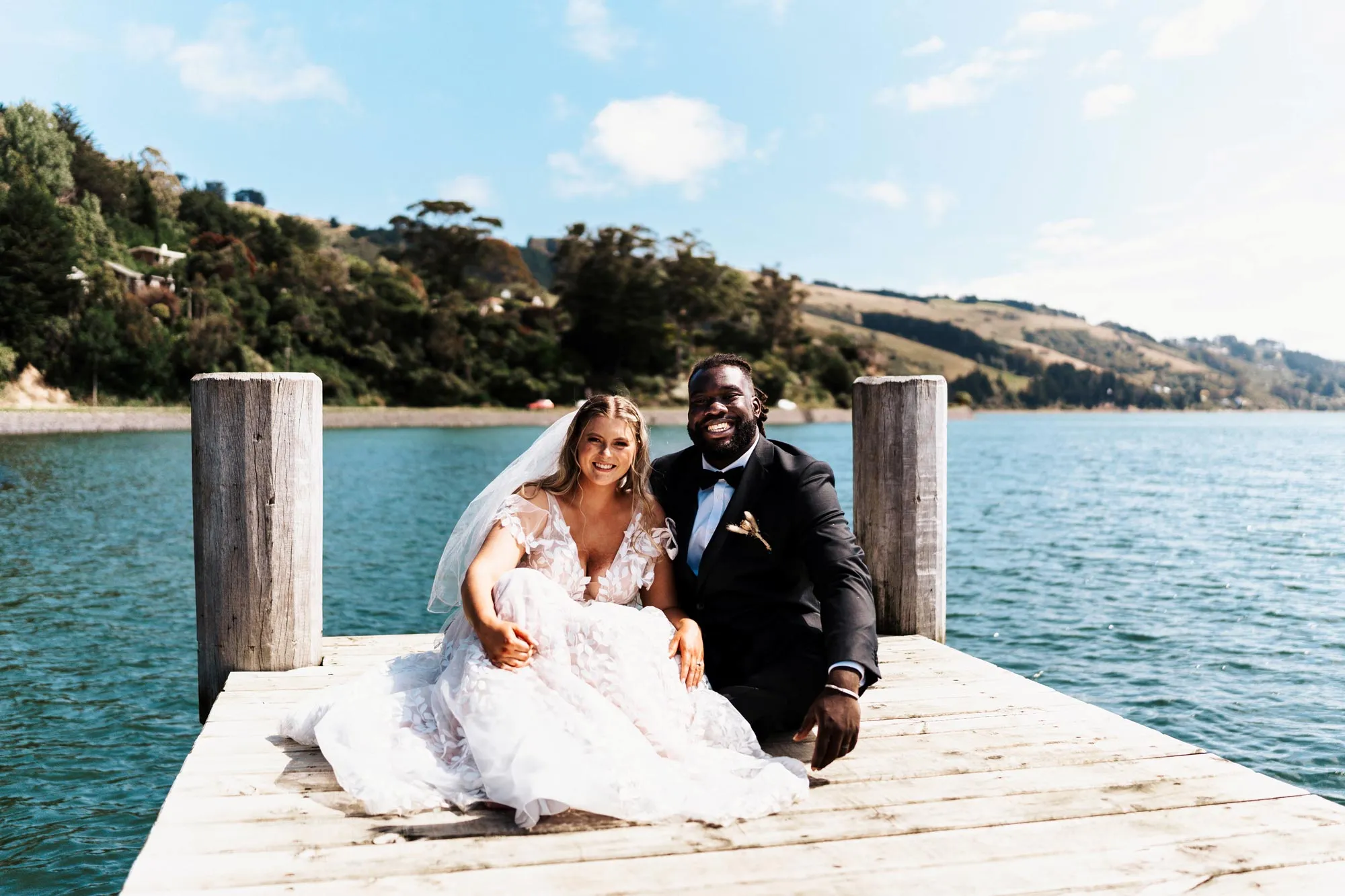 Married couple on sunny wharf in Macandrew Bay