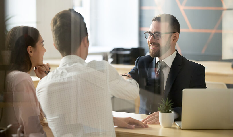 Estate agent negotiating with clients.