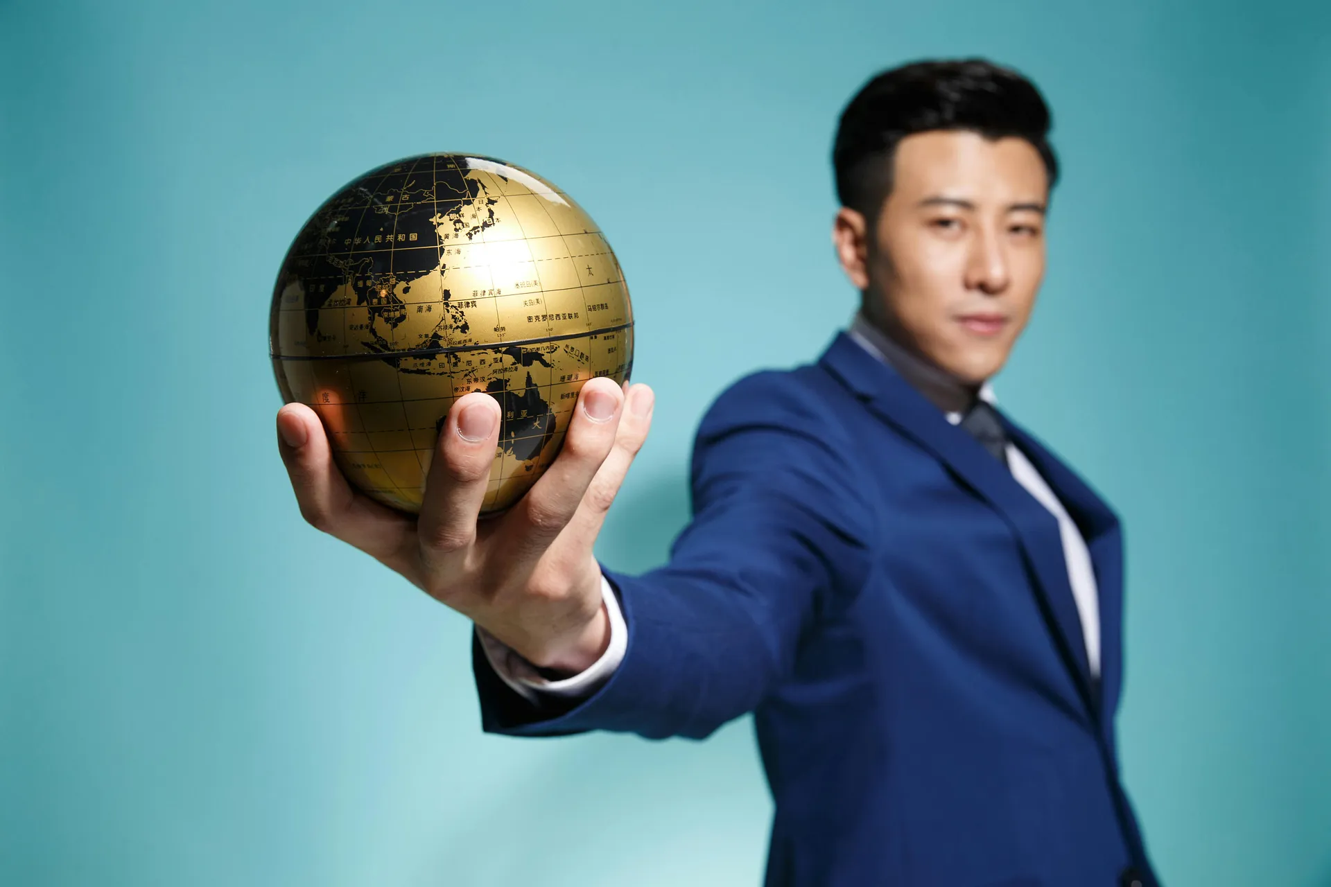 Business leader holding a globe to represent global business expansion, international markets, and worldwide growth opportunities.