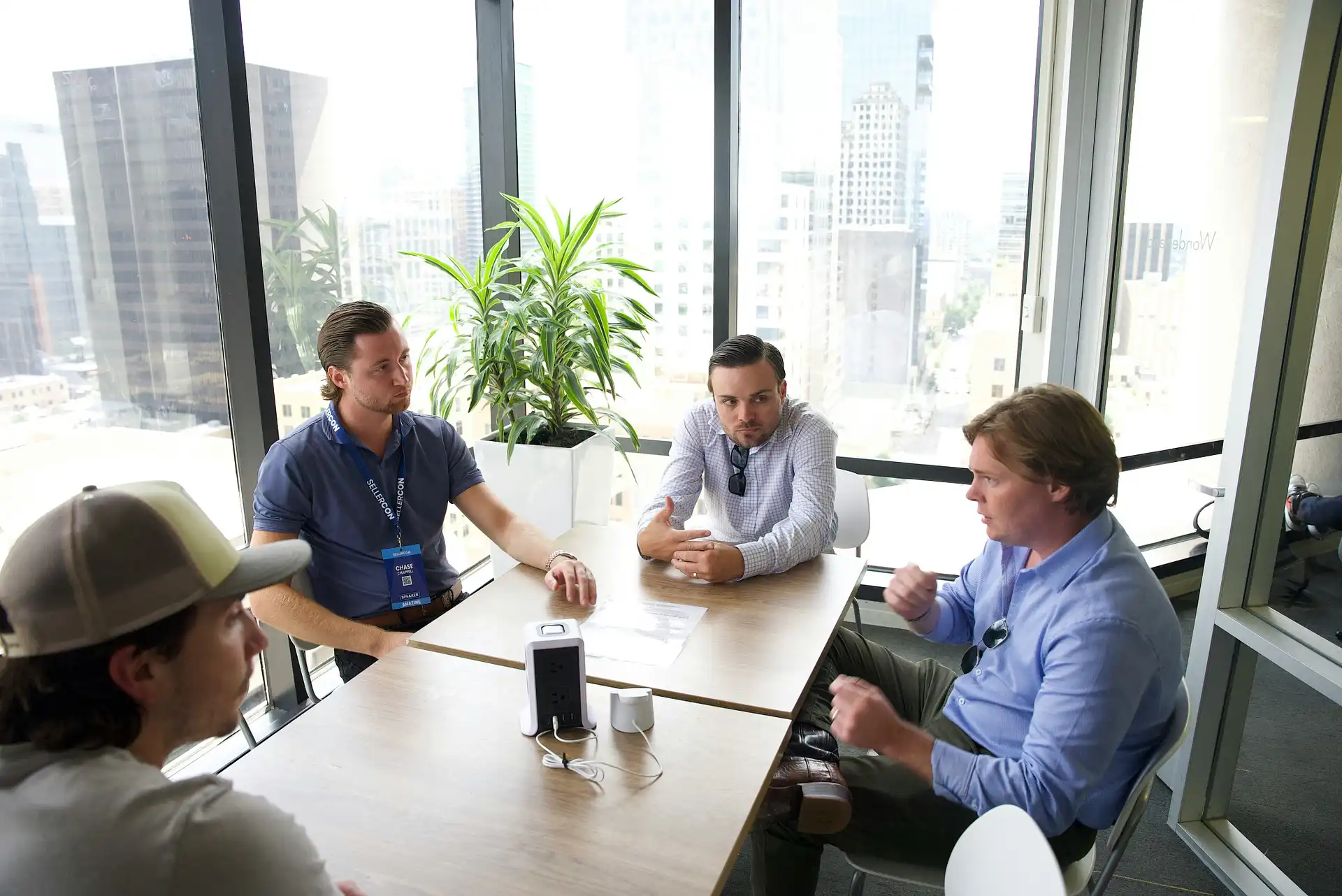 Business professionals having a meeting in a modern office with city views through large windows