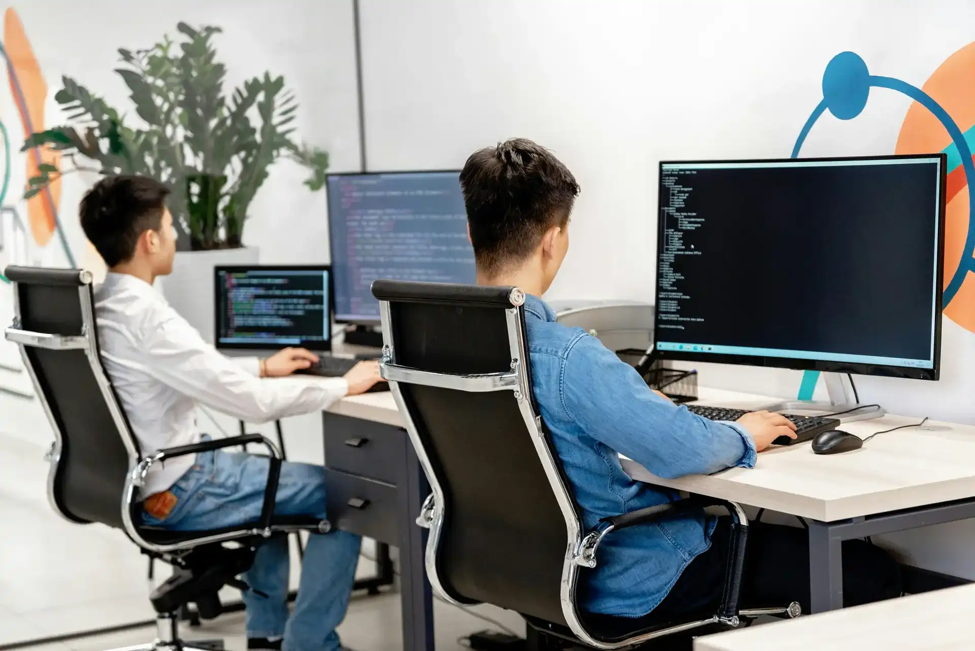 Software developers working in a modern office representing software development outsourcing in the Philippines.