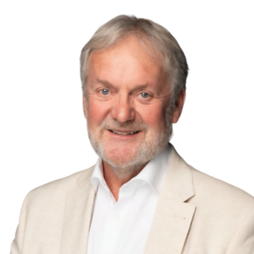 A photo of a smiling man with white hair