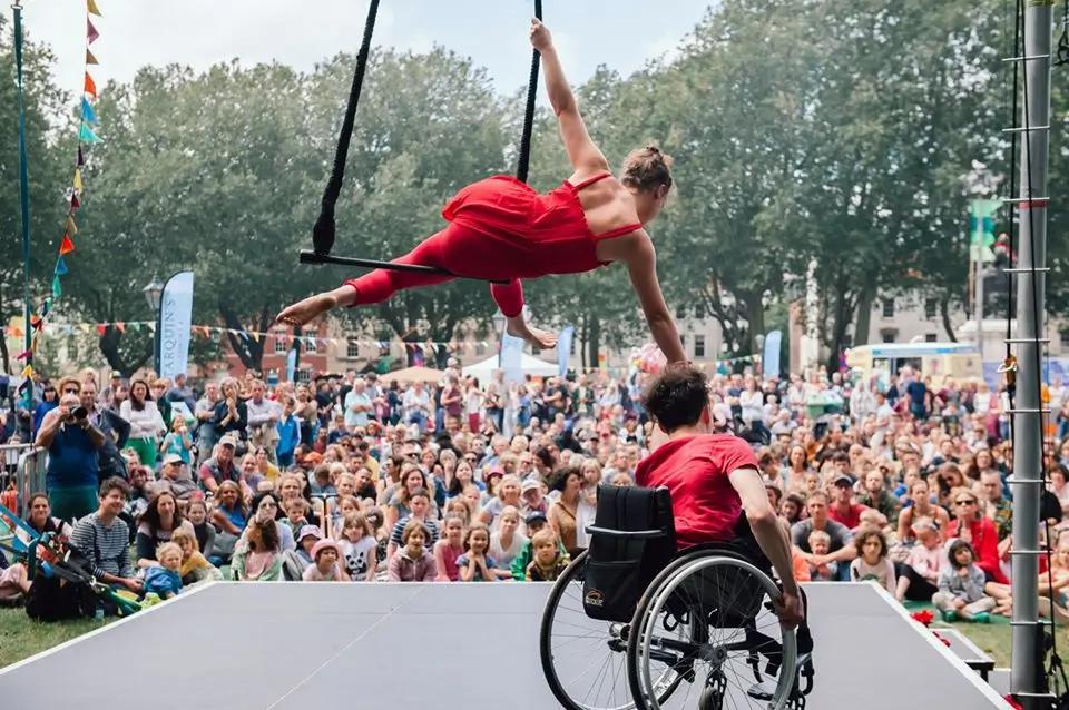 Jonny and Tilly are performing outside in front of a live audience.