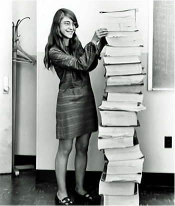 Margaret Hamilton, lead developer of the Appolo 11 software, standing next to the code
