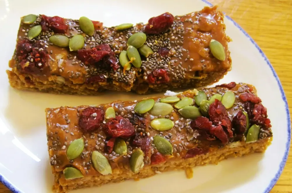 Two seeded granola bars with cranberries and pumpkin seeds
