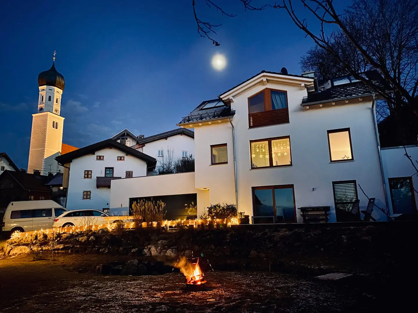 Haus der Ferienwohnung am Abend mit Kirchturm