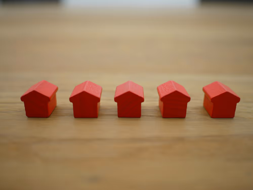 row of 5 small red model houses
