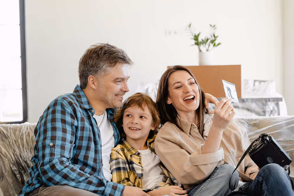 family smiling together on sofa