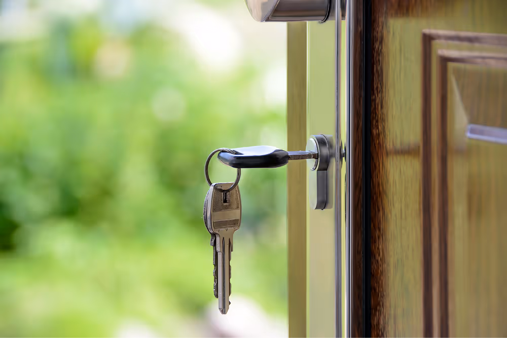 key in door lock with door open looking onto the garden