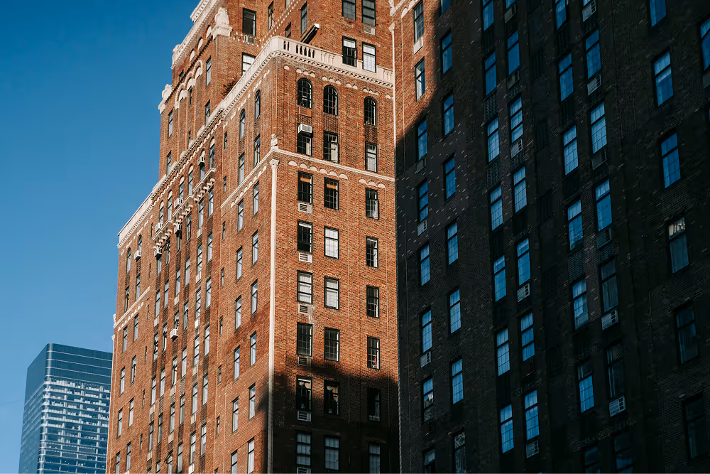 large block of flats with blue skies behind