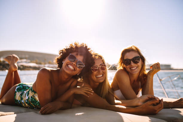 three women on a yacht on vacation