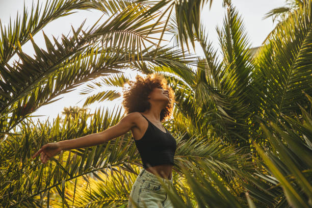 a woman surrounded by palm trees