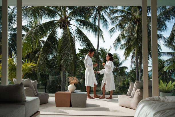 Asian man and woman on a deck in a robe on vacation