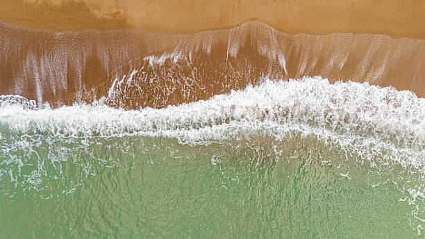 green ocean water waves hitting the beach