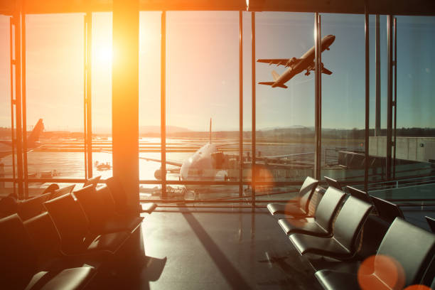 sunset in the airport window looking at planes