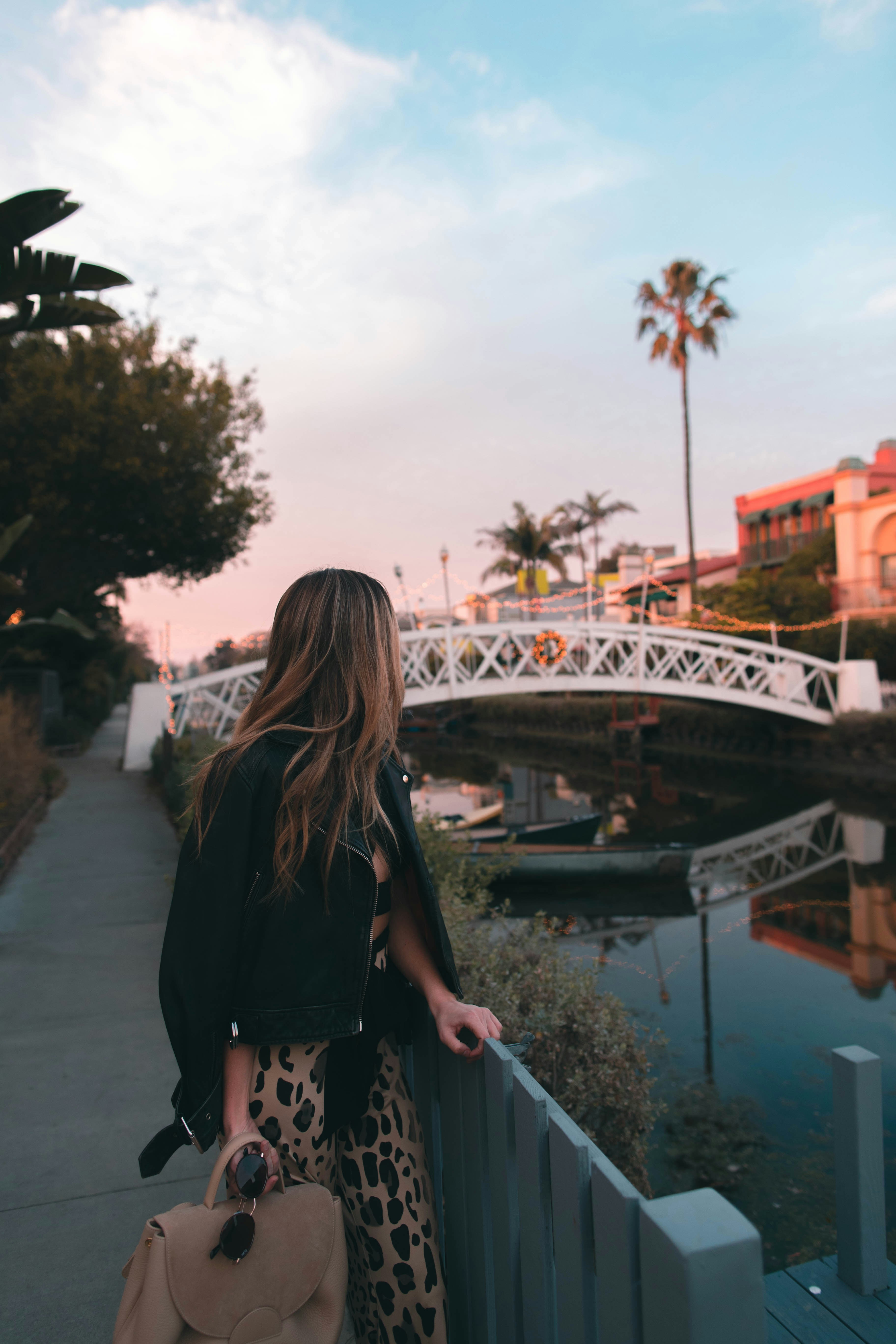 Woman walking through the Venice canals in California visibly working through relationship struggles