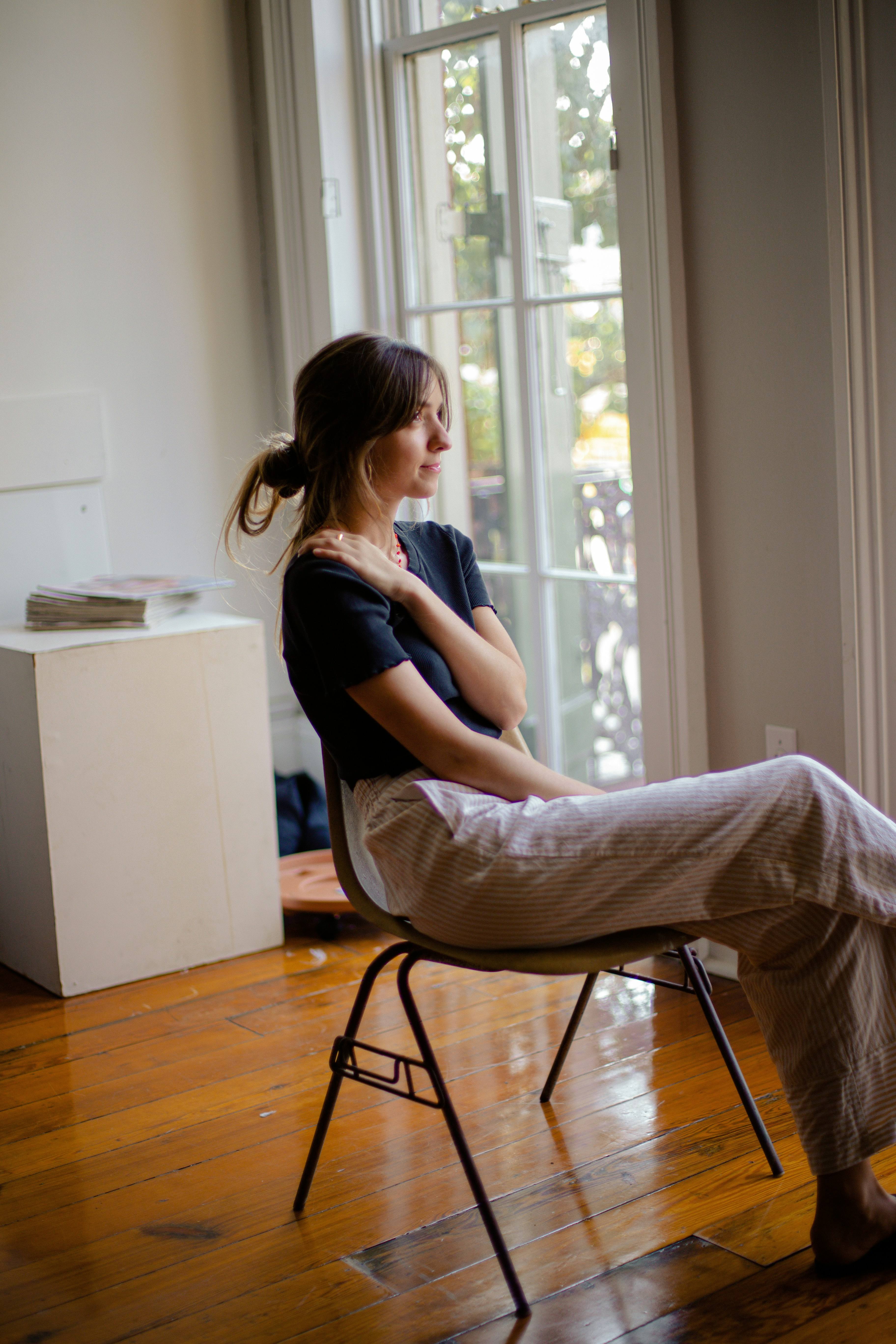 Woman relaxing in a chair by a sunlit window during a psychotherapy session in West LA