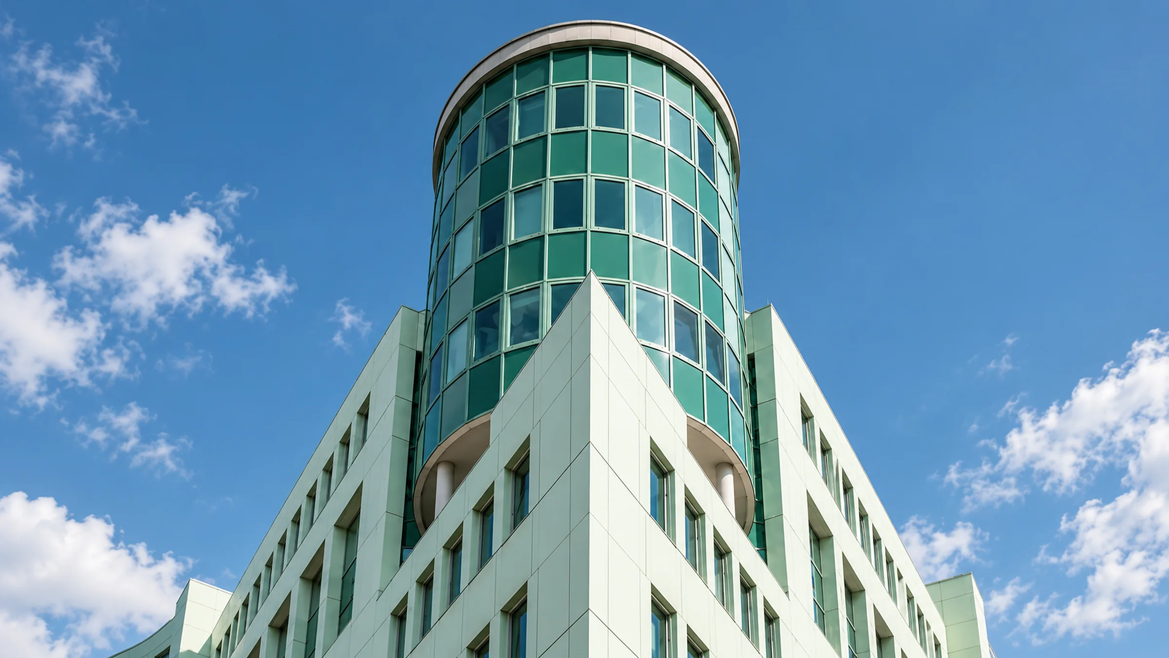 Rounded glass tower and geometric façade of the GODU building in Berlin-Tempelhof