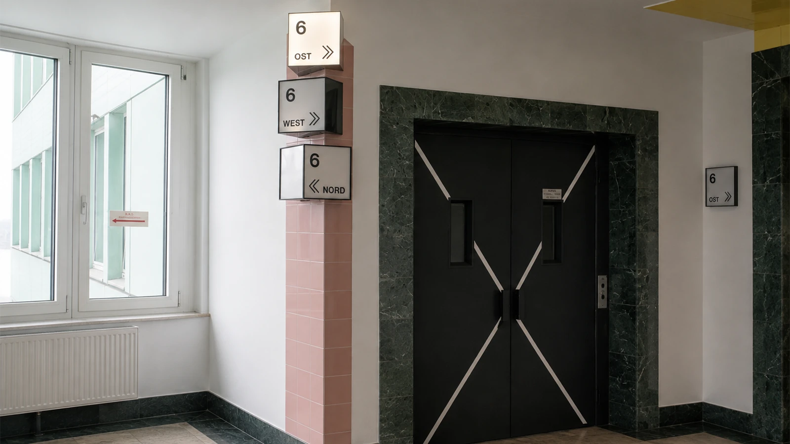 Freight lift and floor wayfinding on the sixth floor of the GODU building