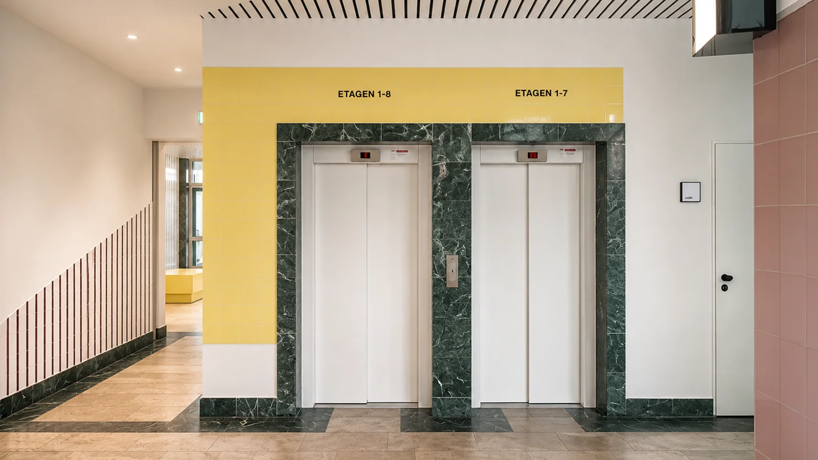 Two passenger lifts in the colourful GODU foyer