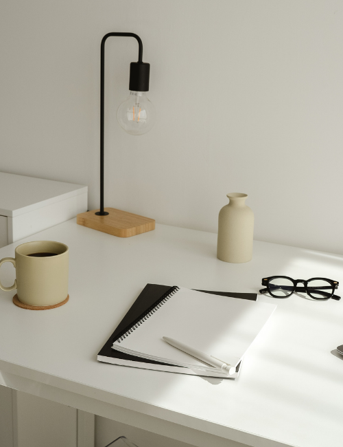 Almaraya desktop with a lamp, notebook and cofee in aesthetic manner.