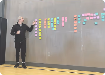 CTO Ralph Gootee presenting in front of a wall covered with post-it notes