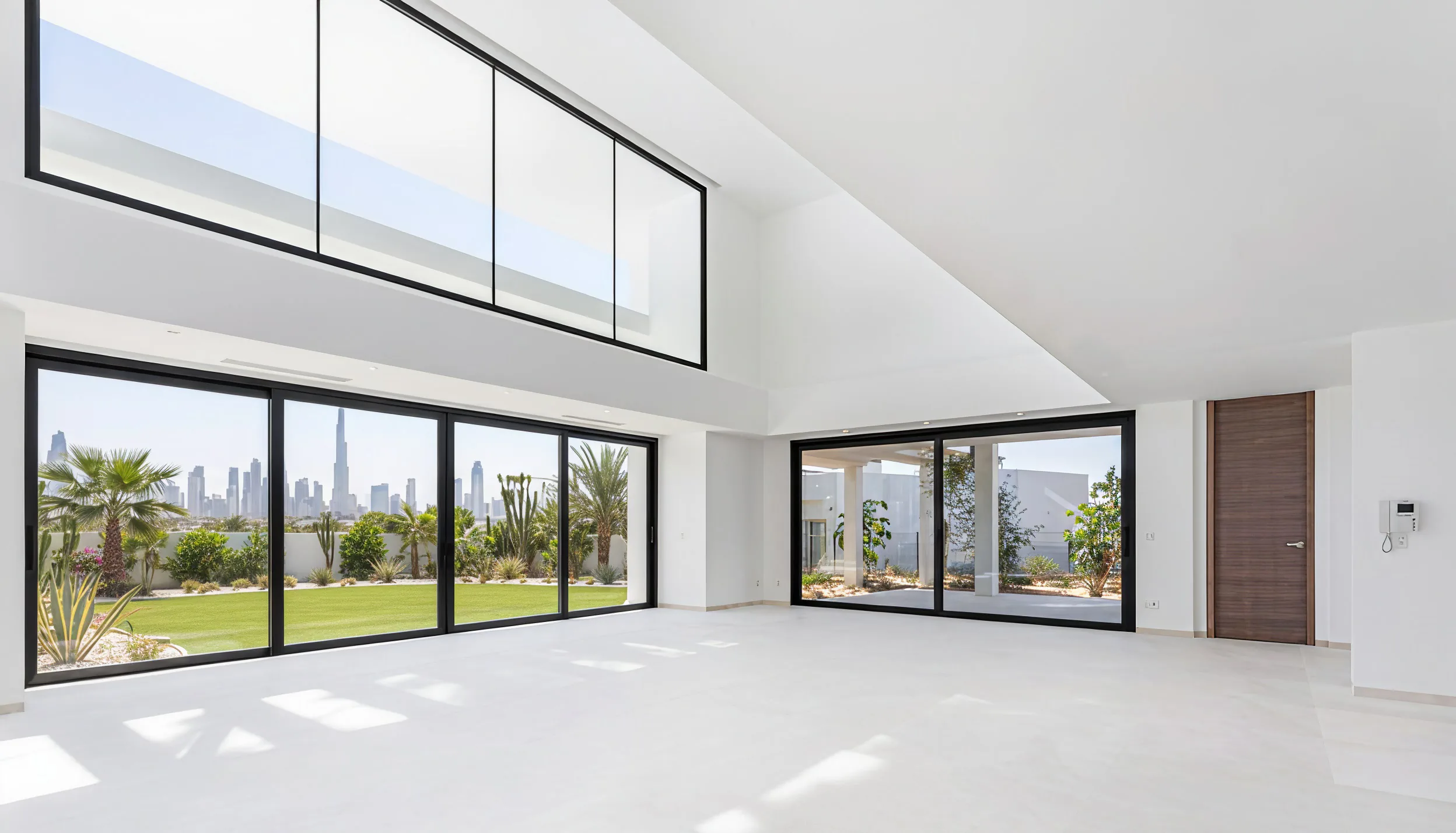 Empty finished living room in a Dubai villa, floor-to-ceiling glass with the city skyline beyond