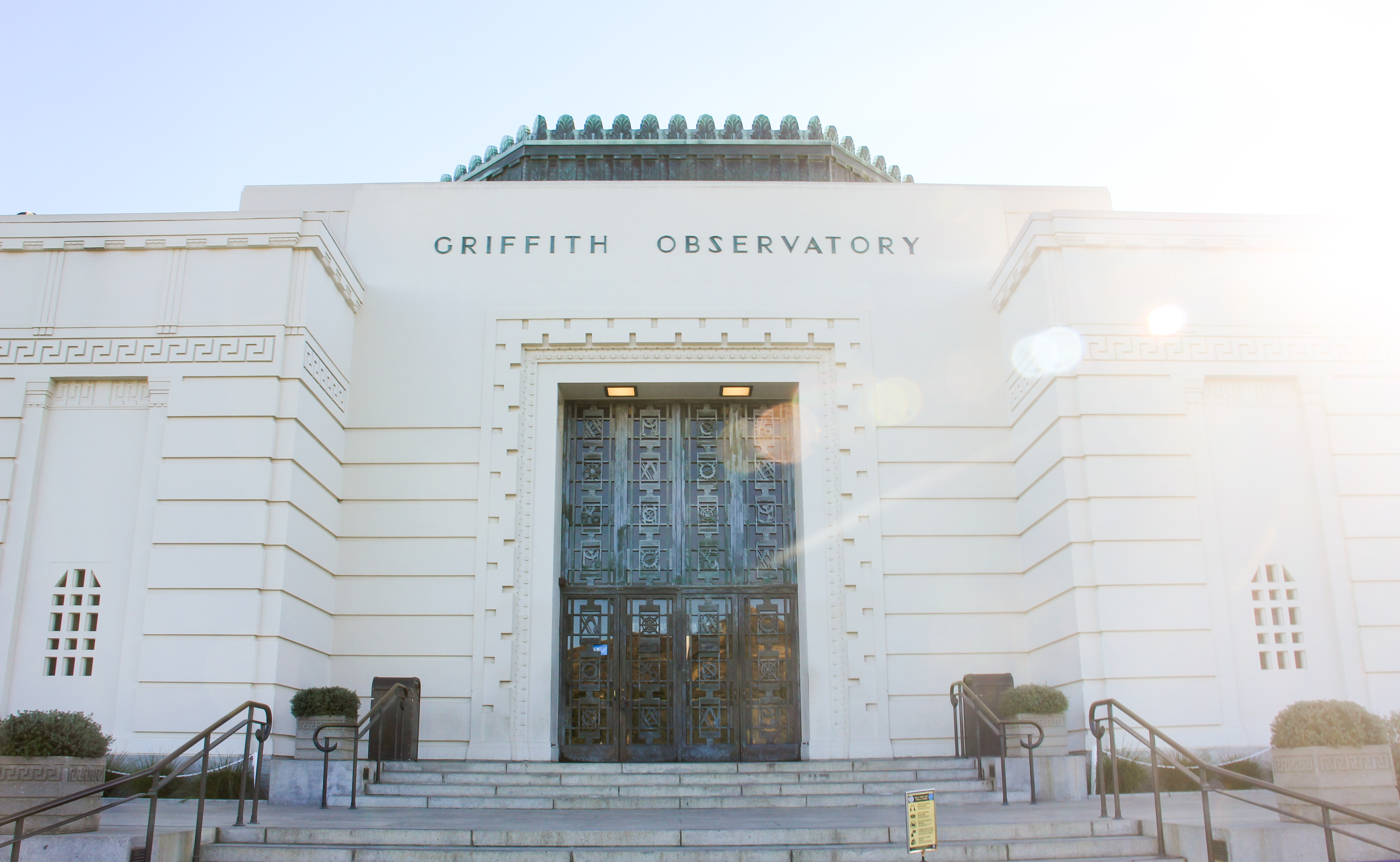 Image of the sun shining on the Observatory front doors. 