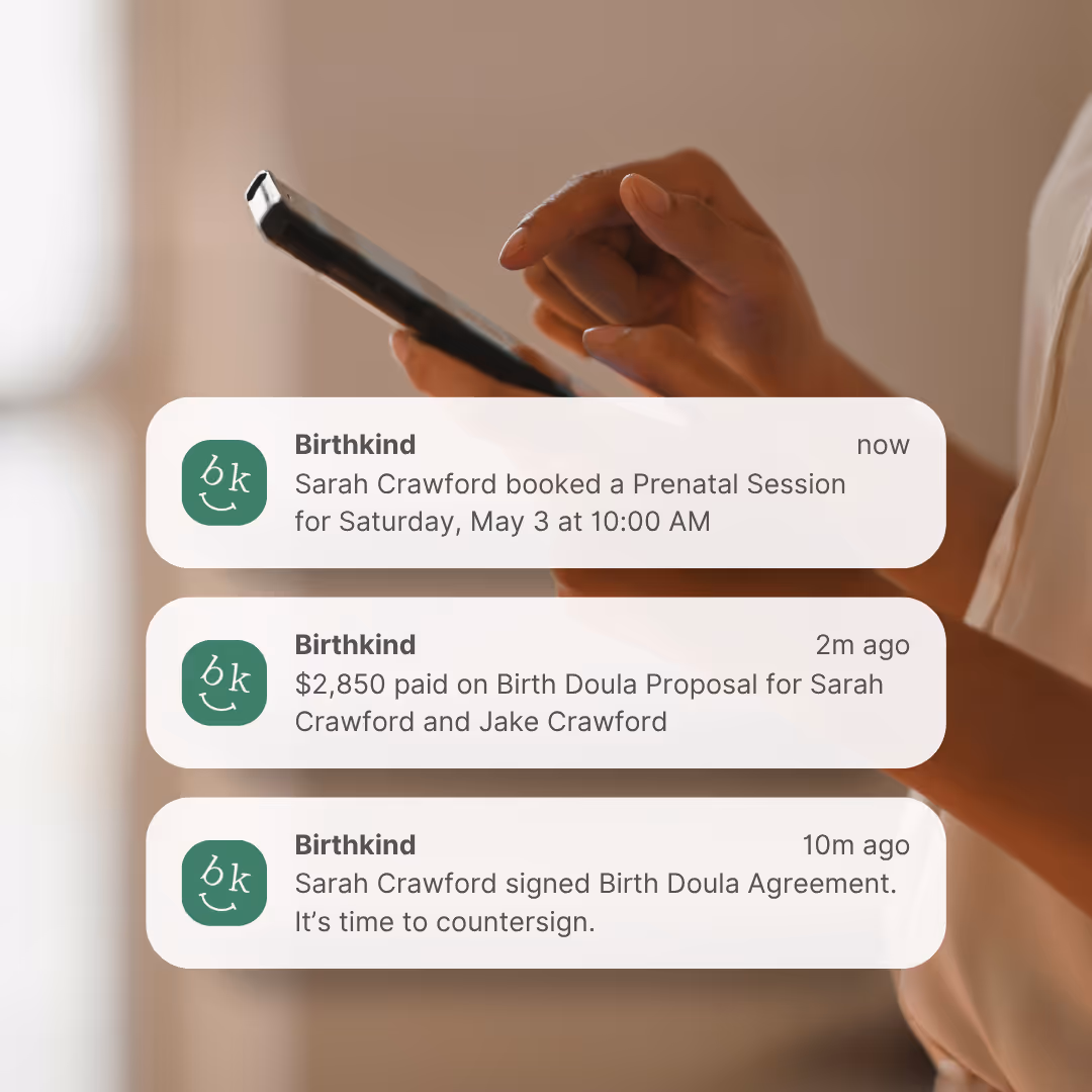 Birthkind app notifications showing doula booking confirmations, payment processing, and contract signing reminders on mobile phone