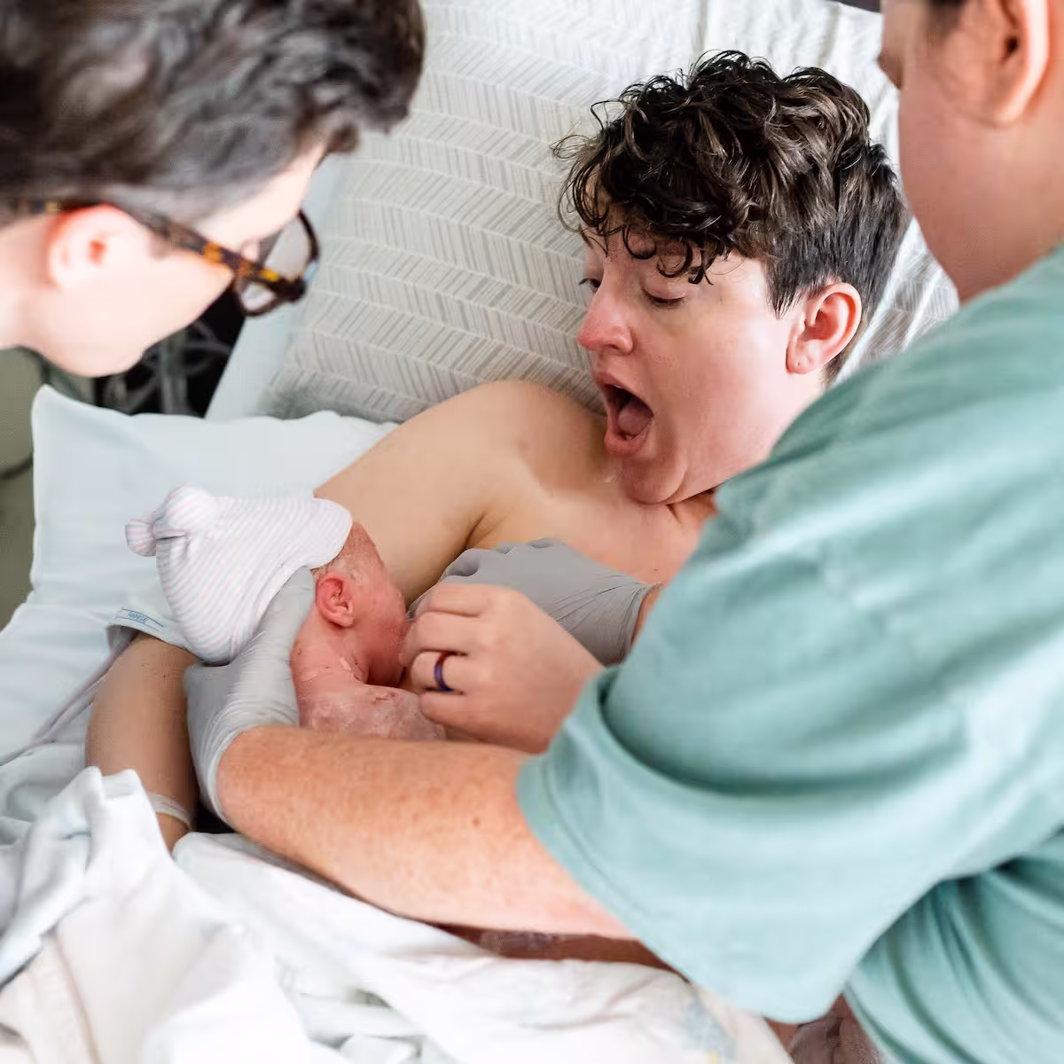 Doula supporting a parent with their first breastfeeding session.