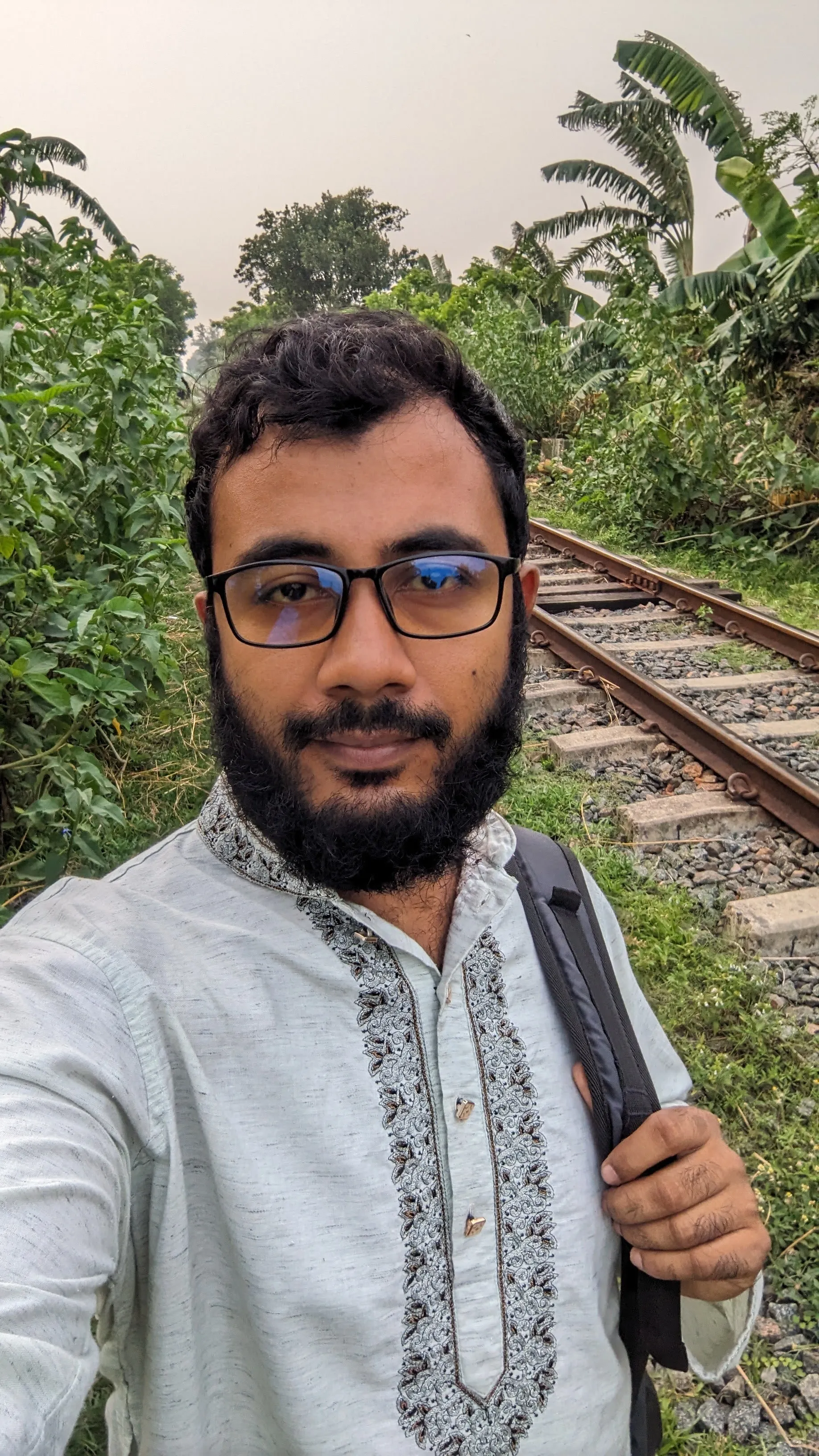 A dashing UI/UX designer wearing coat. 