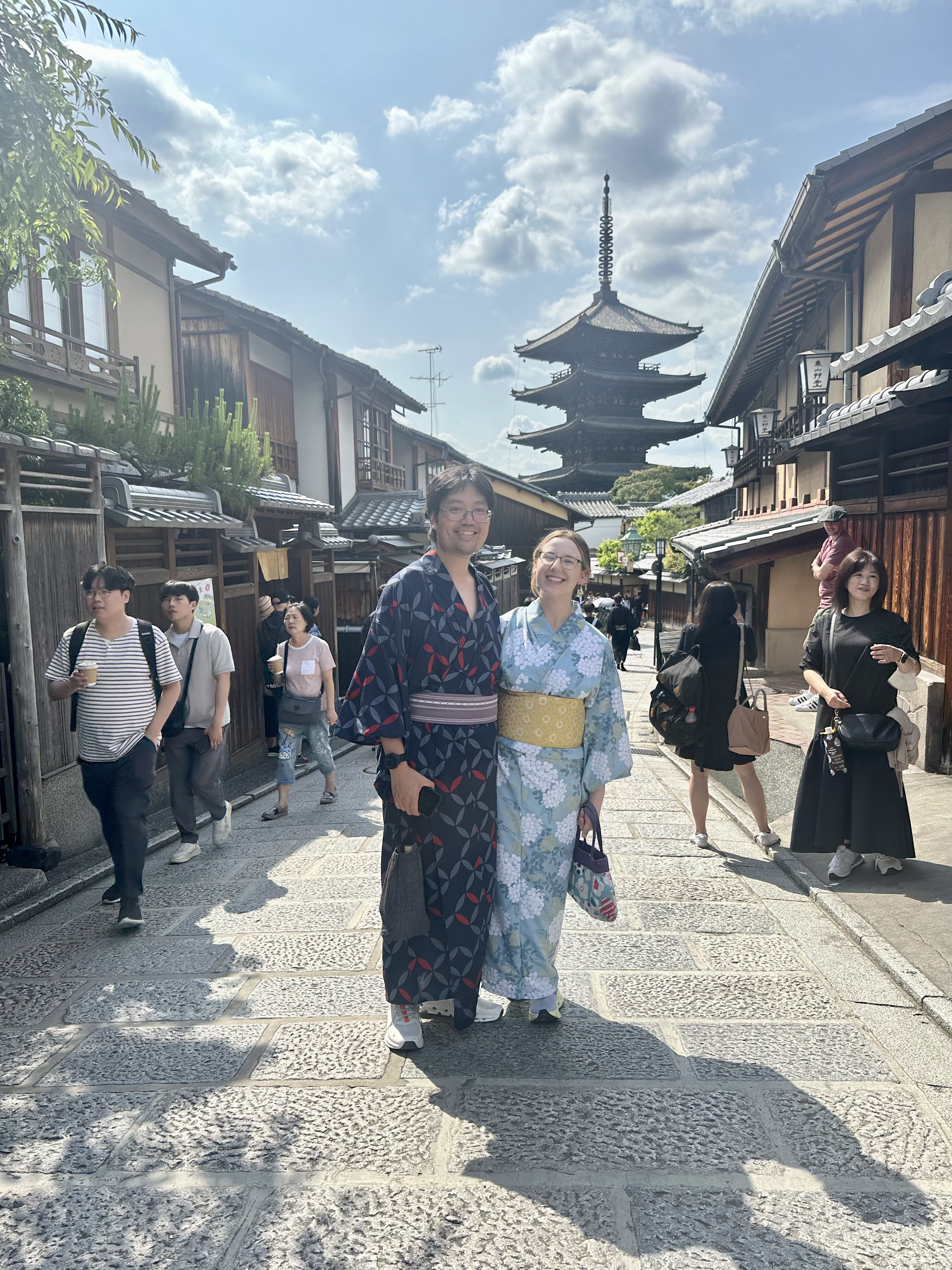 Mari-Alina Timoshchuk and Cassidy Sung in Kyoto Japan in Kimonos on a sunny day with a temple in the background