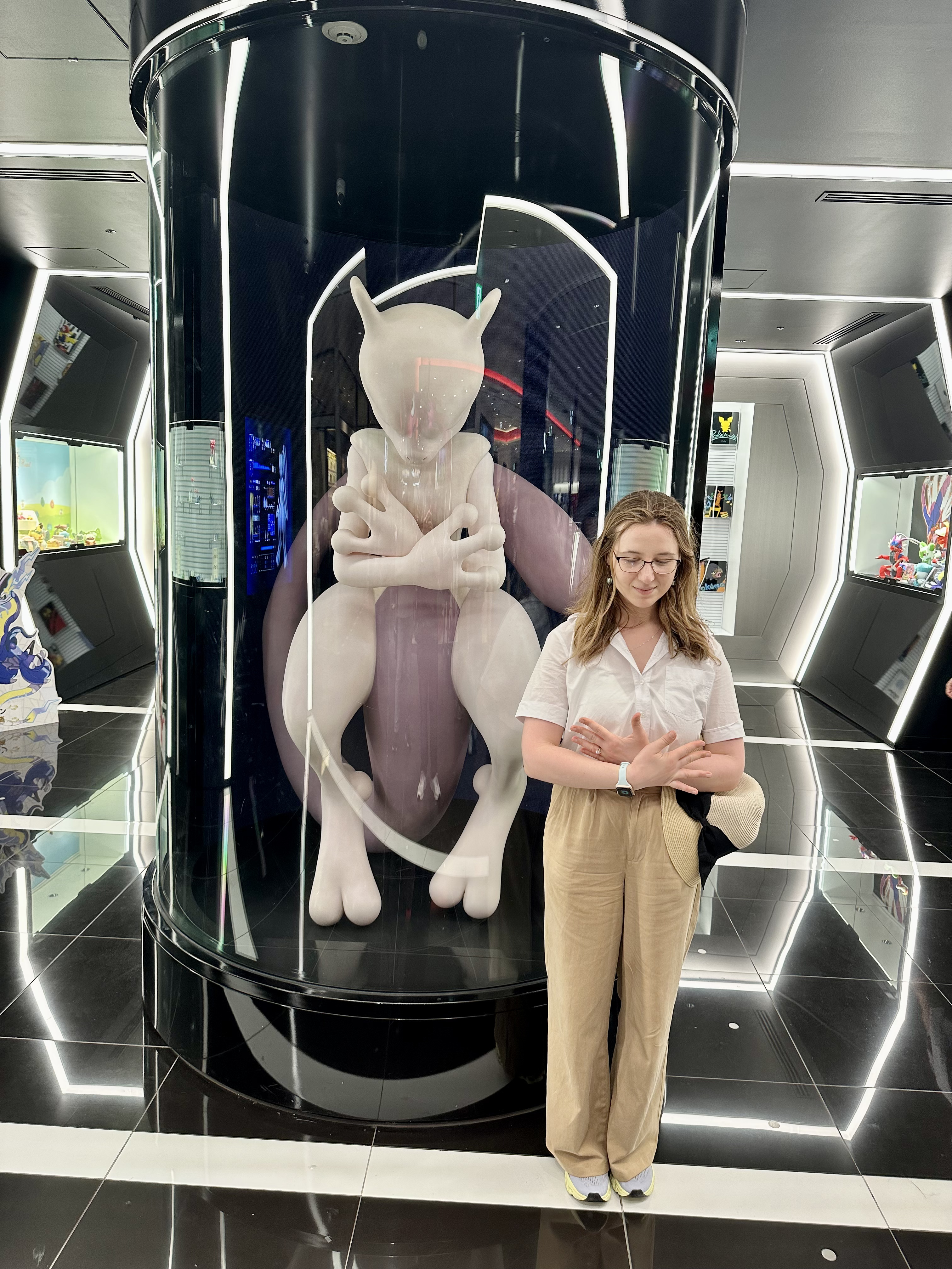 Mari-Alina Timoshchuk in the Nintendo store in Japan next to a life size statue of MewTwo