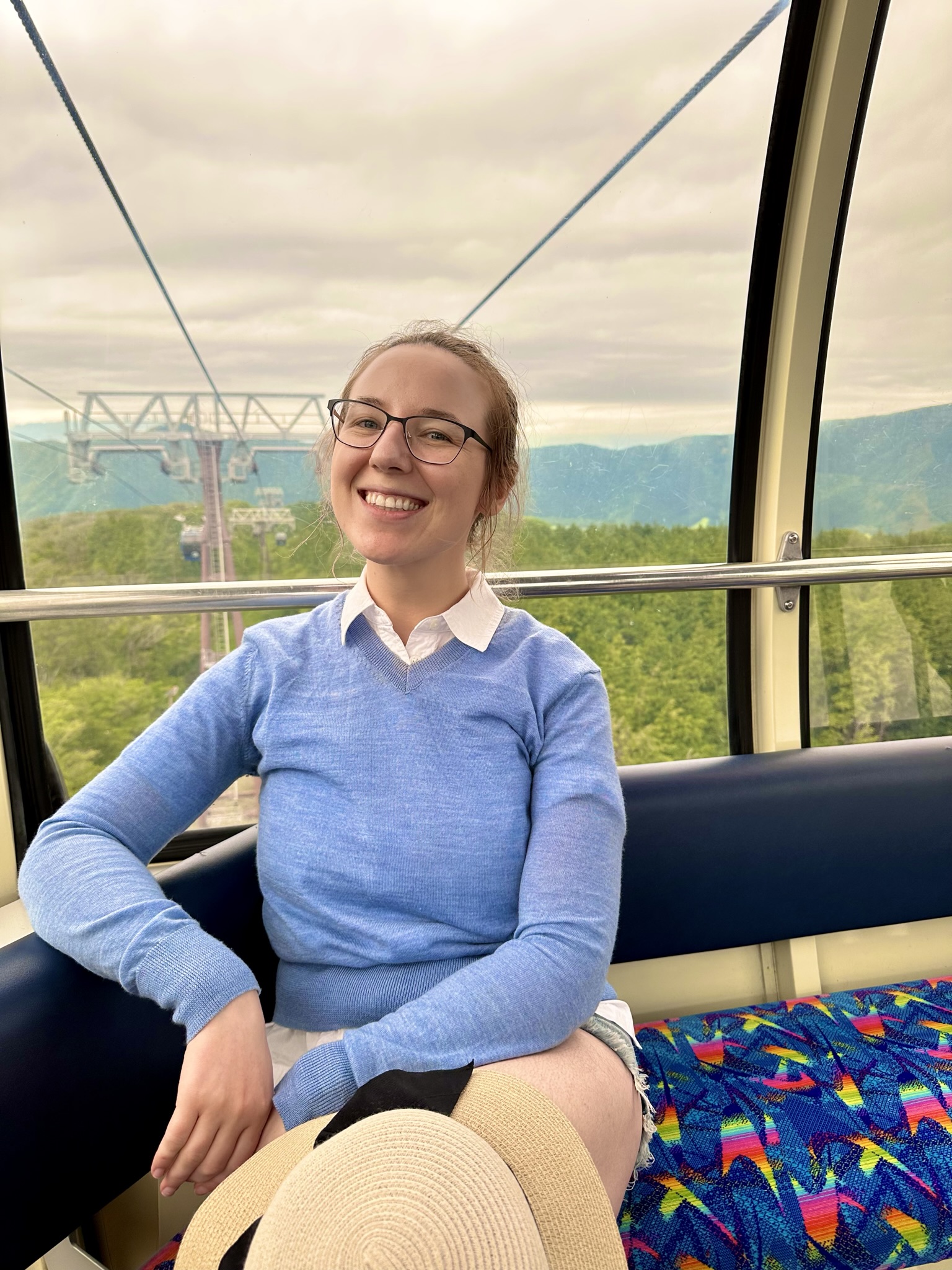 Mar-Alina Timoshchuk sitting on a lift at a hot spring in Japan