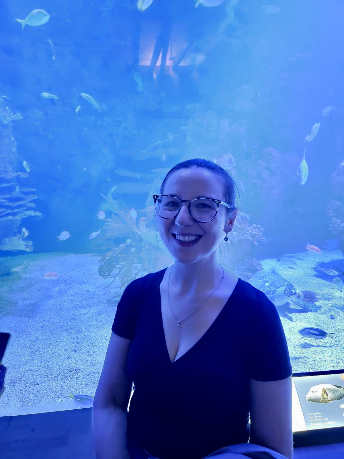 Mari-Alina Timoshchuk at a aquarium in Span with fish in the background