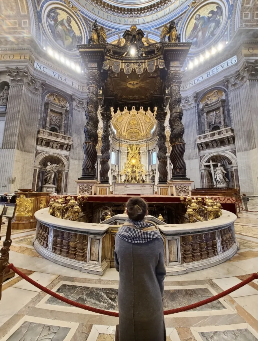 Mari-Alina Timoshchuk in front of the tomb of Saint Peter at Saint Peter's Basilica in Rome