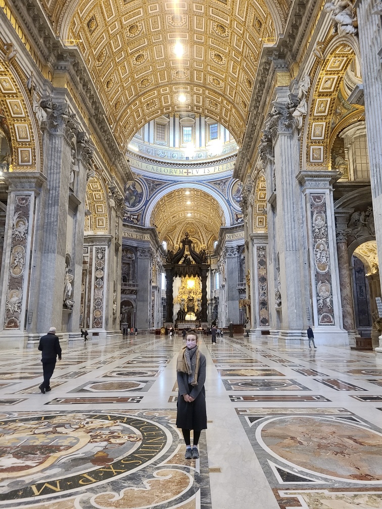 Mari-Alina Timoshchuk standing in the hall of Saint Peter's Basilica which is nearly empty
