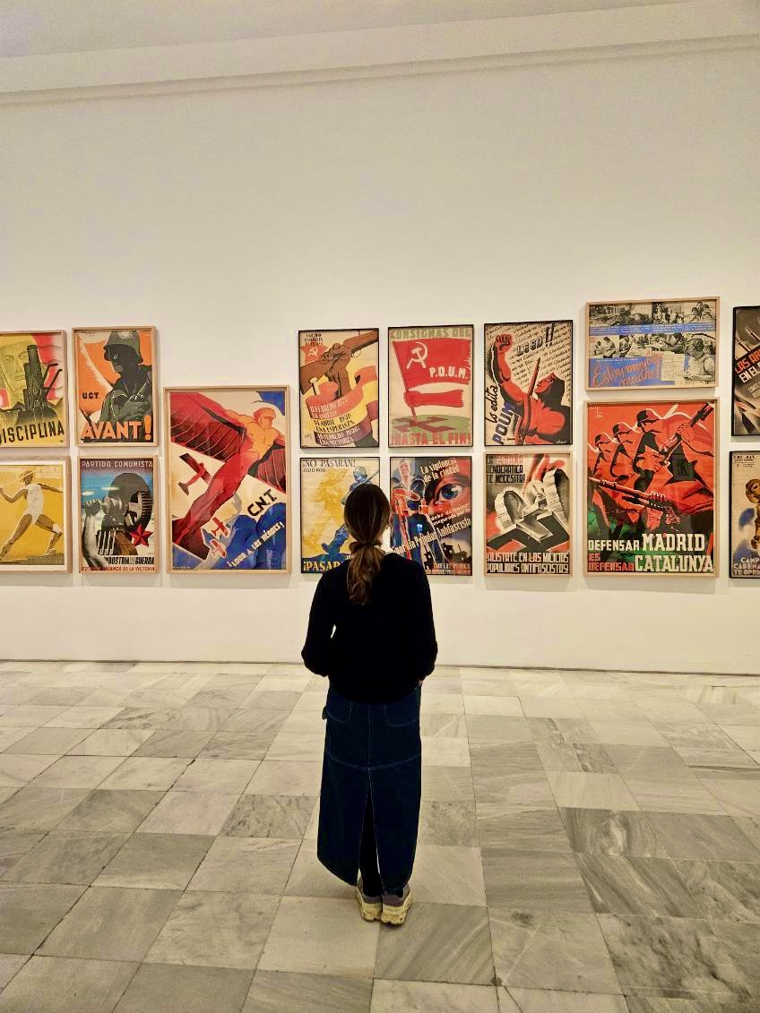 Mari-Alina Timoshchuk standing in front of a wall of posters in Madrid Spain
