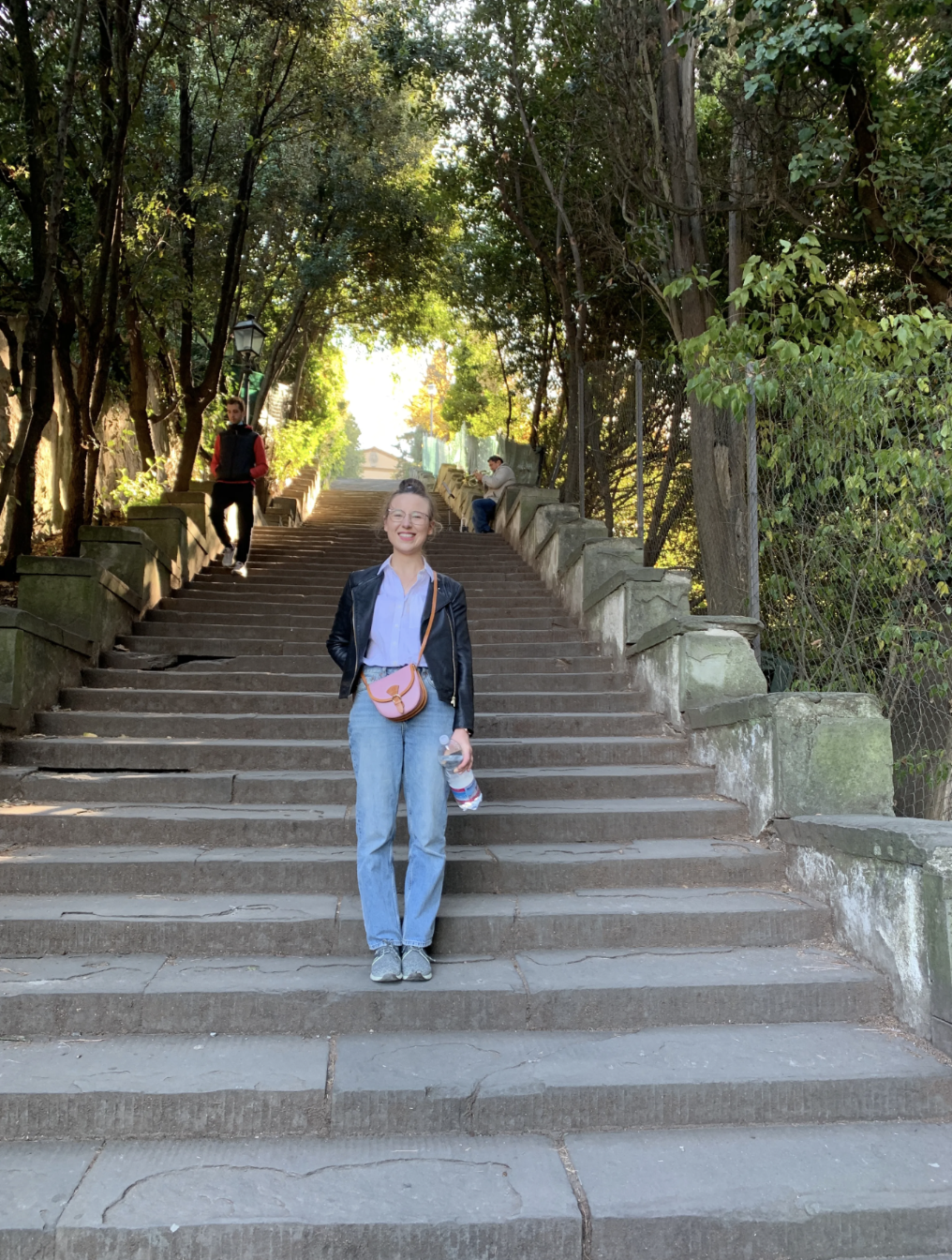 Mari-Alina Timoshchuk on some steps in Florence Italy with trees behind her