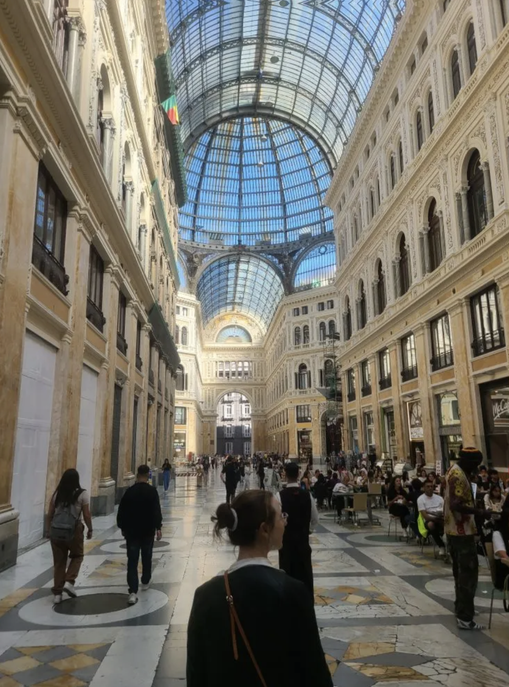 Mari-Allina Timoshchuk in a large mall in Italy with a glass done.