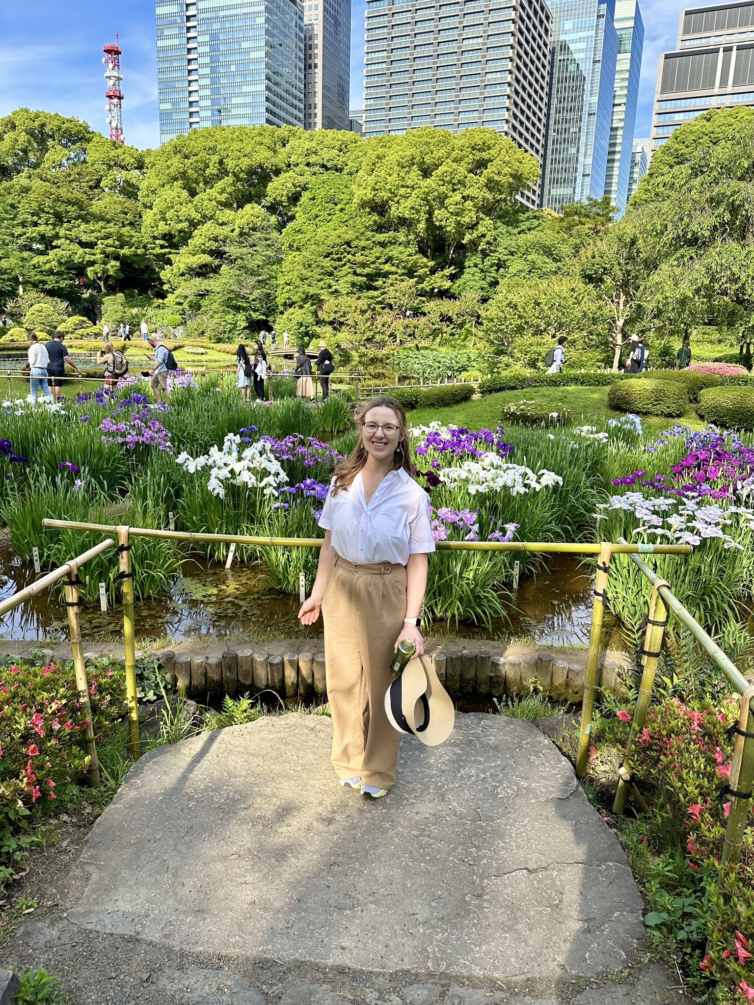 Mari-Alina Timoshchuk at the Imperial Palace East Gardens next to a lot of Iris flowers
