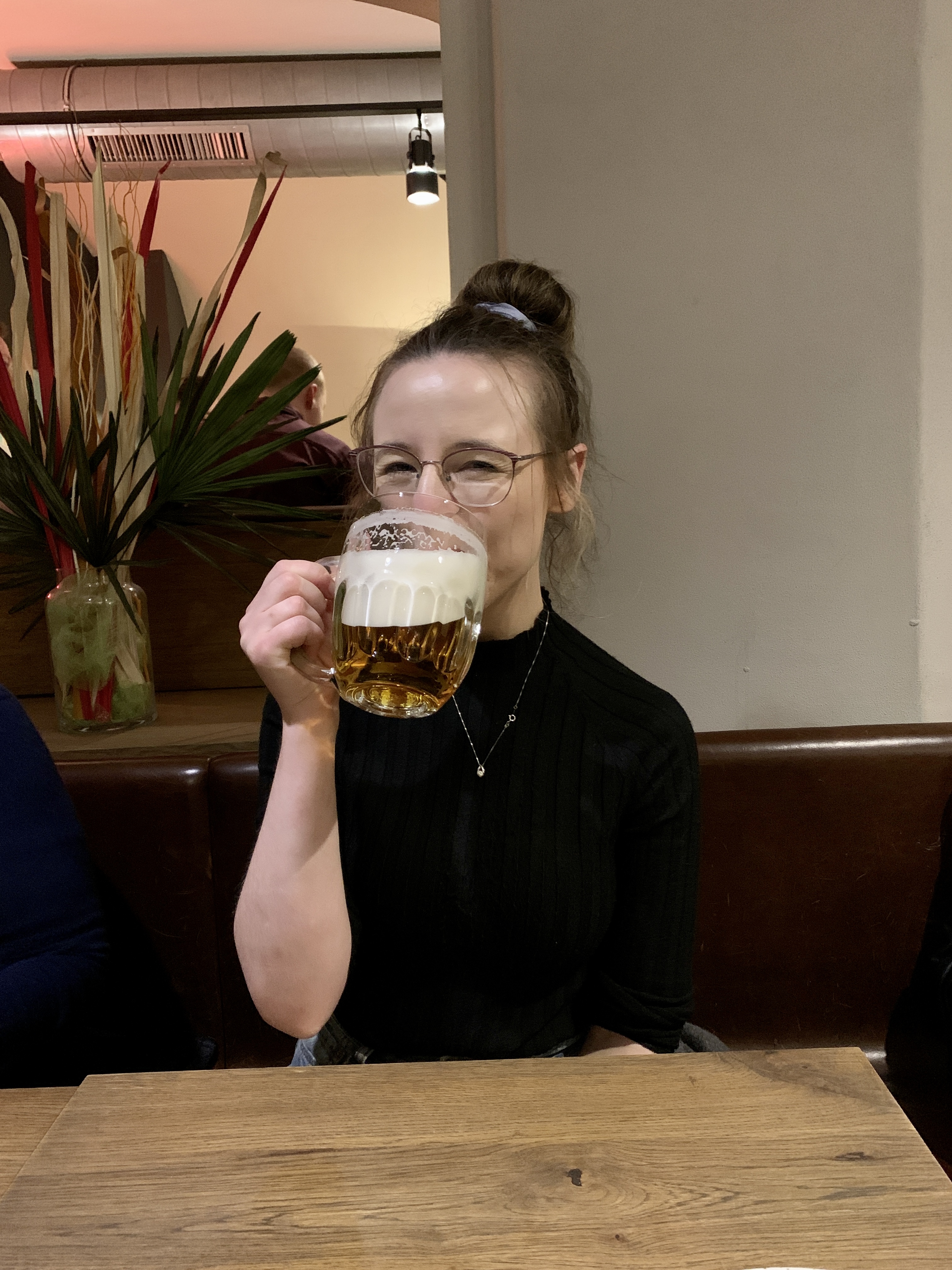 Mari-Alina Timoshchuk drinking a large class of beer in Prague