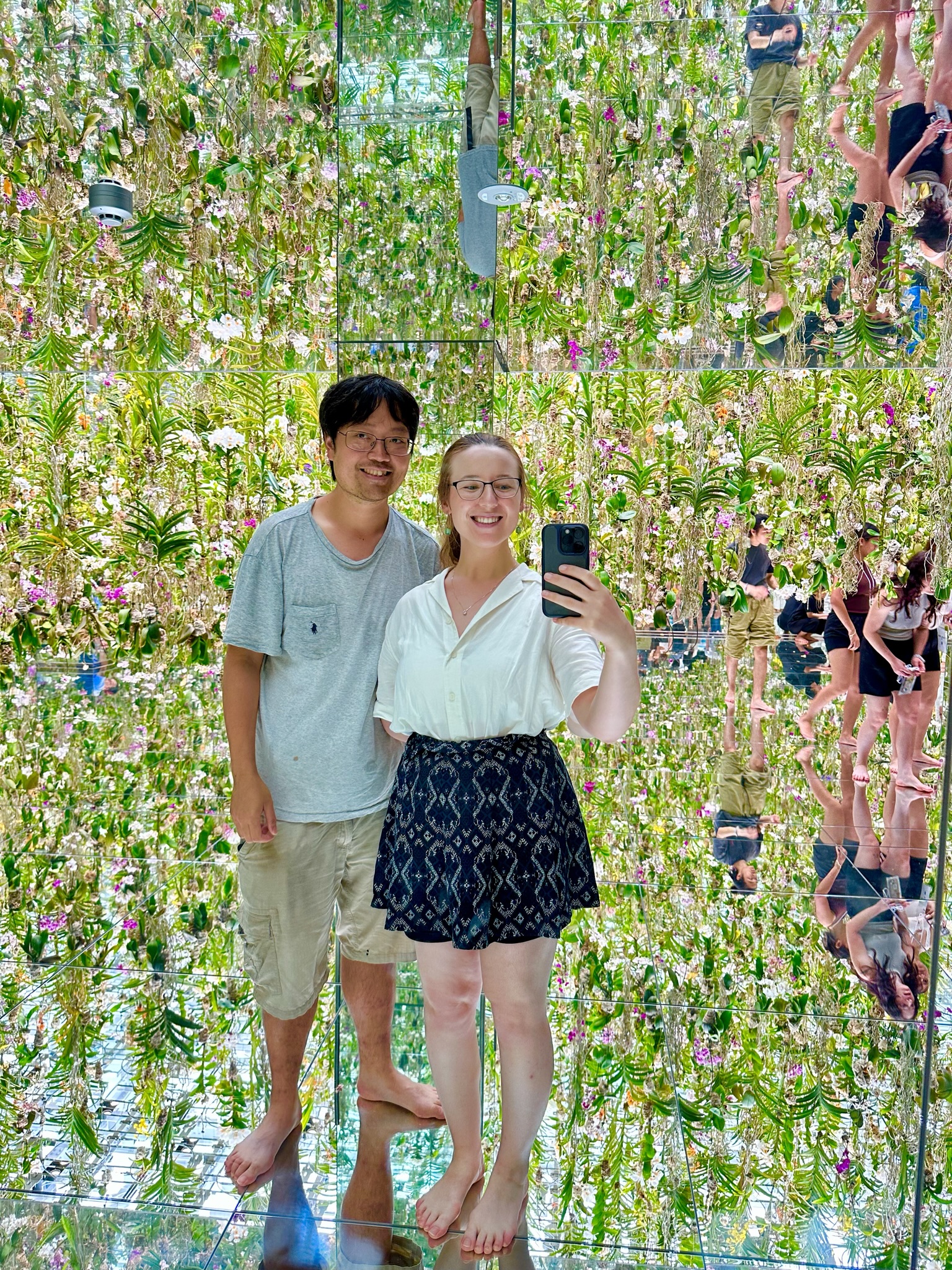 Mari-Alina Timoshchuk and Cassidy Sung surrounded by flowers at an art exhibit in Tokyo Japan 