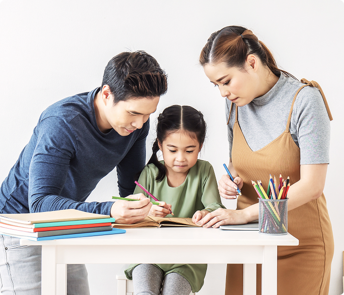 Parents helping their child with homework or home learning