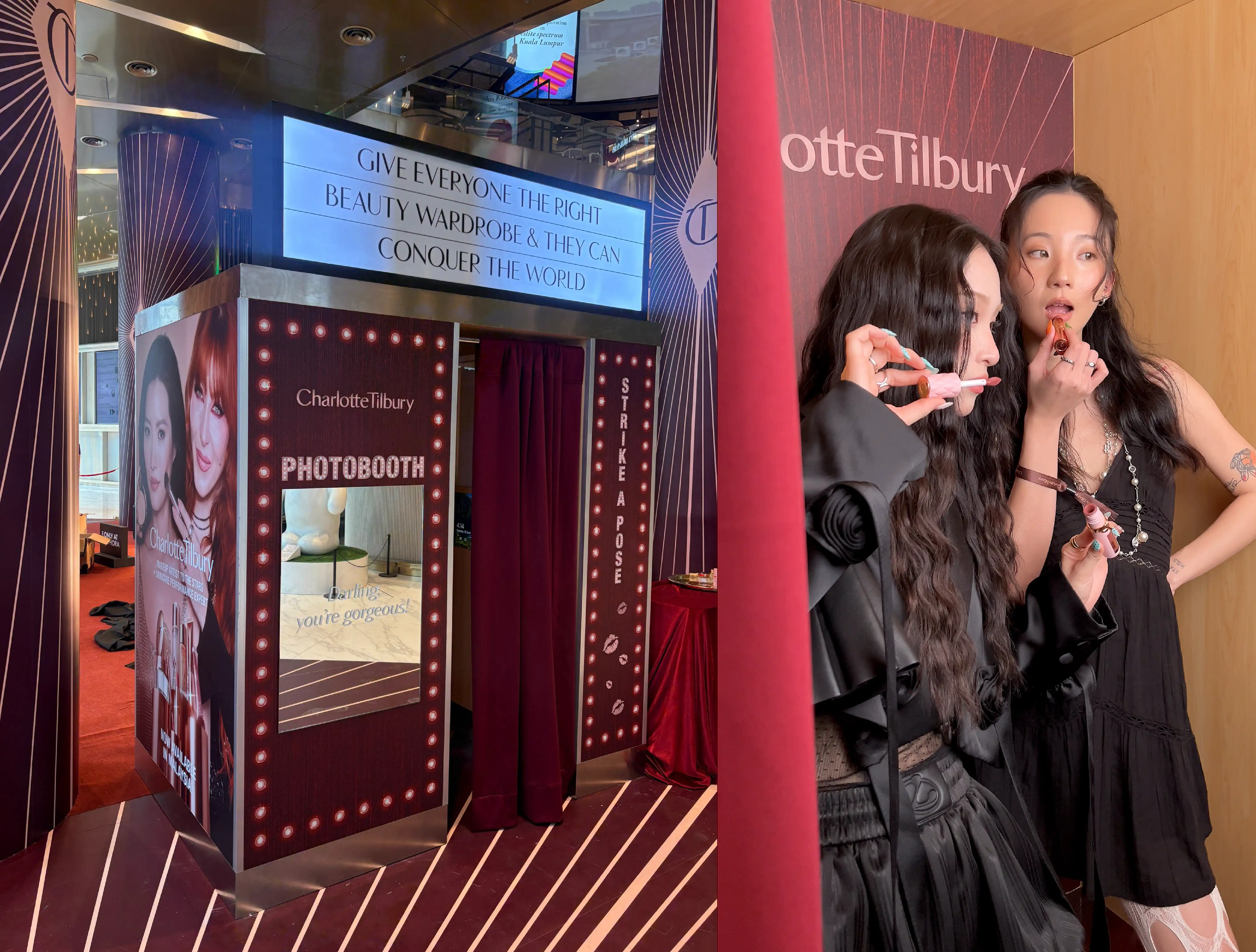 Charlotte Tilbury branded photo booth with strike a pose signage and two guests posing