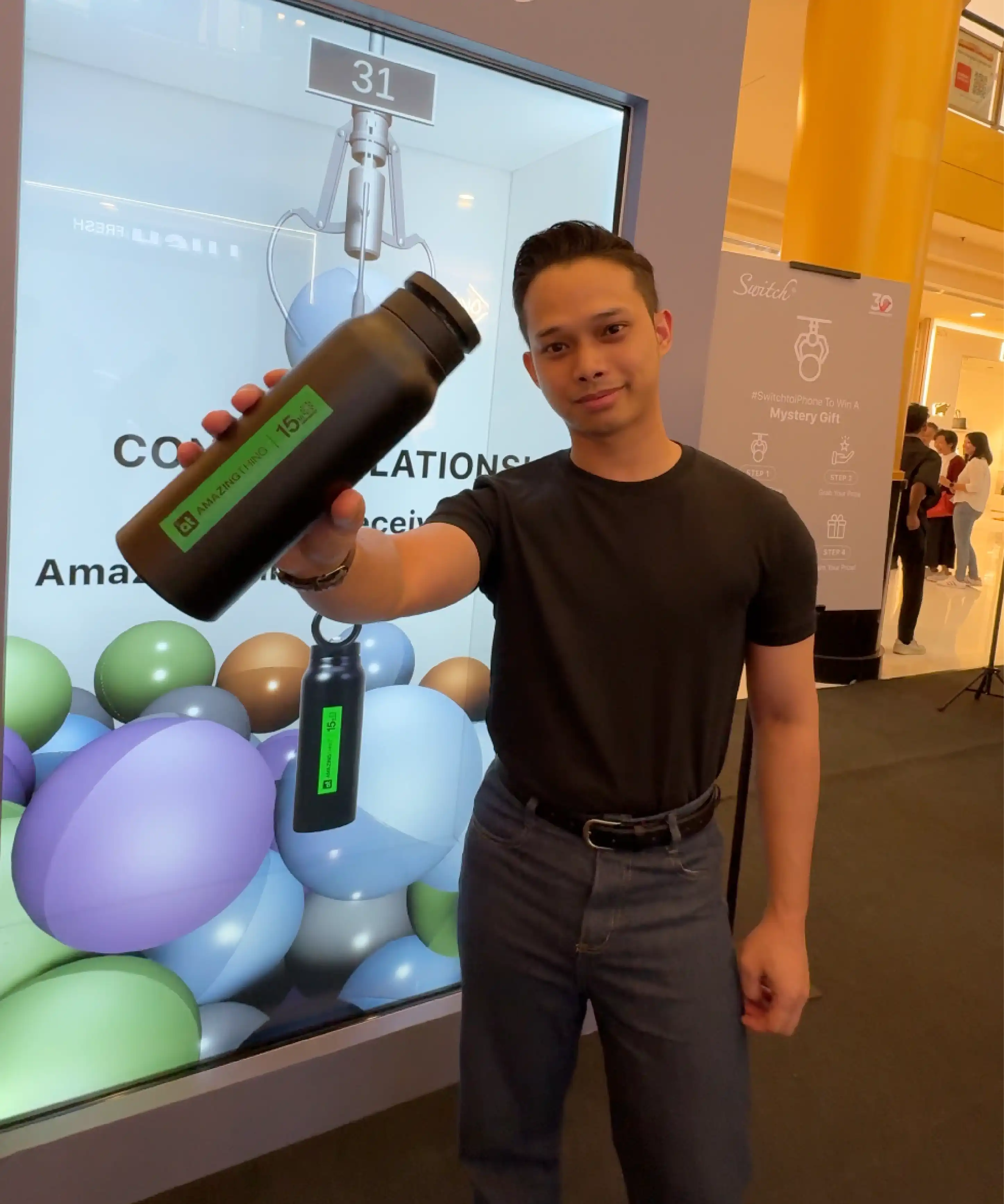 Crowd engagement at Switch Mobile iPhone 17 launch featuring Instamedia IMX Engine digital claw machine with dual iPad touchscreen control options