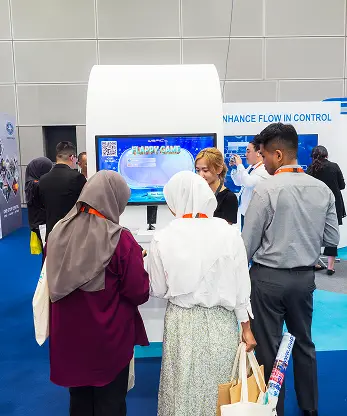 Wefic OTC Exhibition booth visitors engaging multiplayer game Malaysia